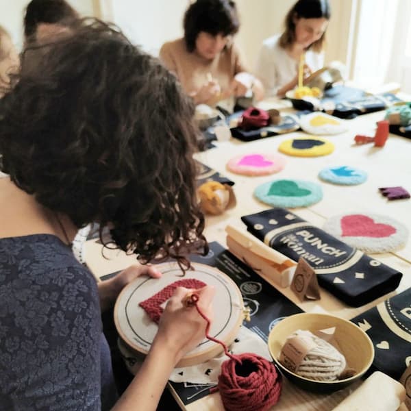 Participants in the punch needle Moomzart workshop embroidering with Oxford needles and natural wool.